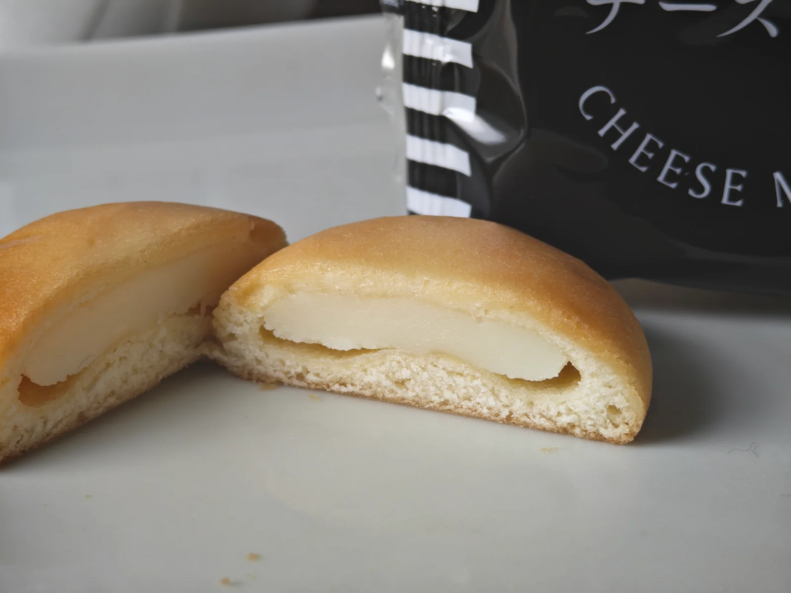 Cross-section of Hyuga Hogaya Cheese Manju showing moist dough and cheese