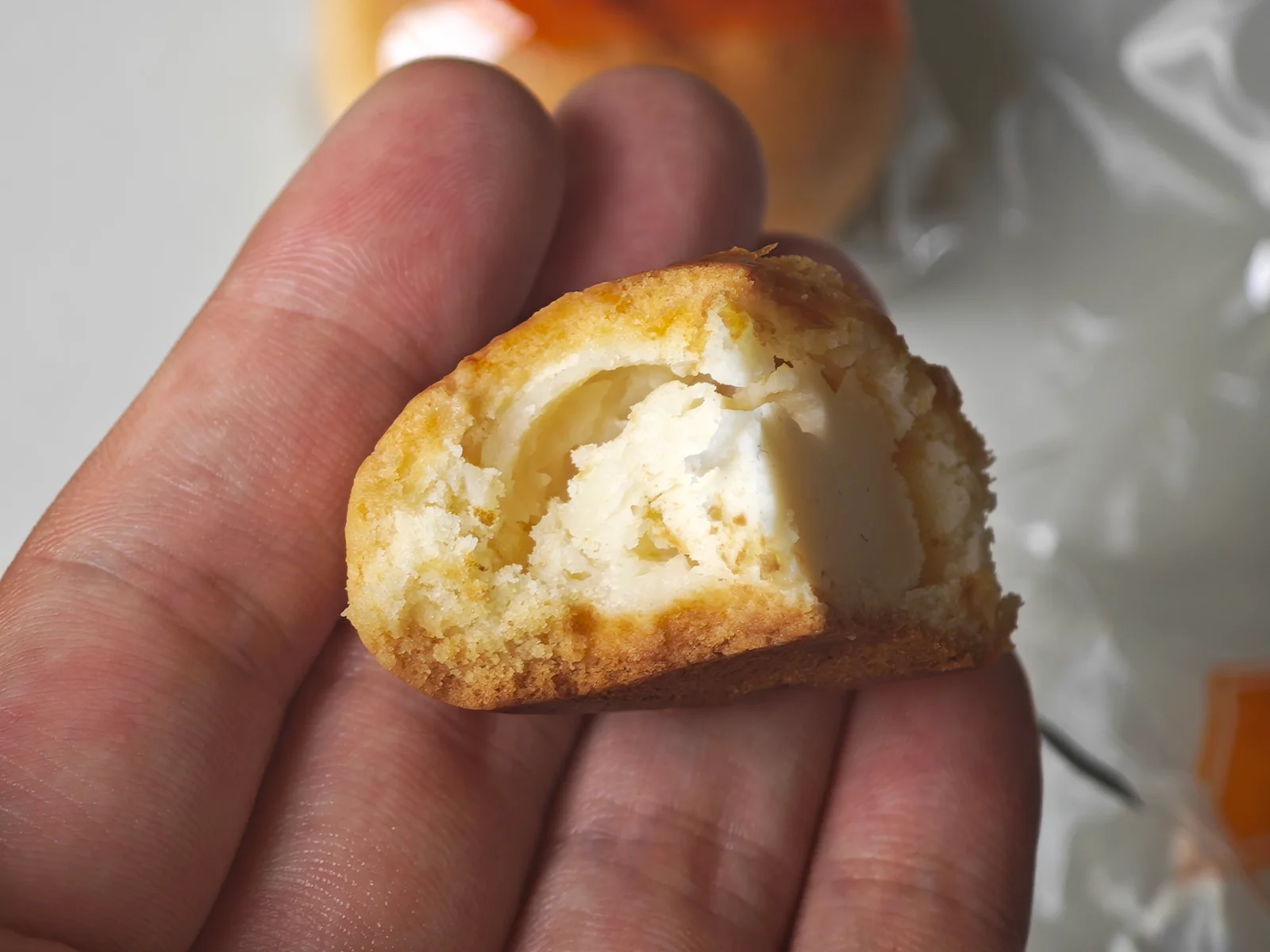 Fugetsudo Original Cheese Manju held to show size and filling
