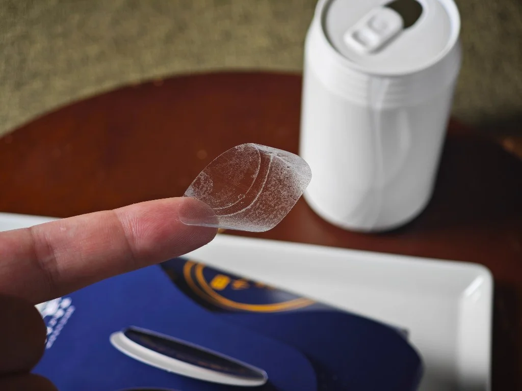 Clear package seal held on a fingertip