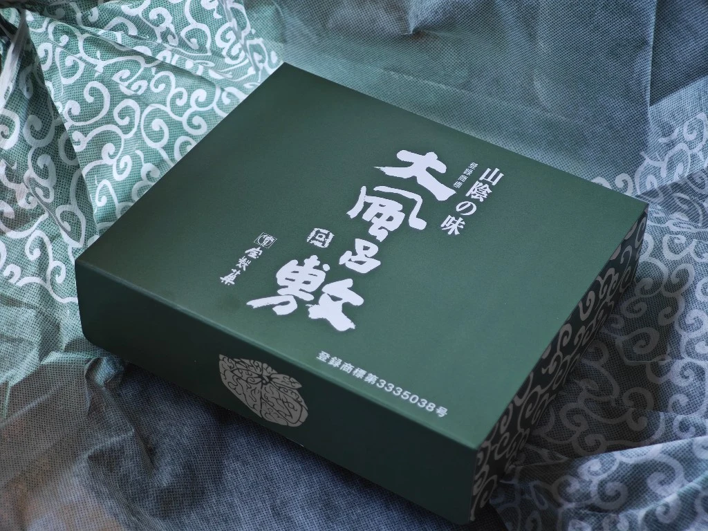 Dark green inner box revealed after the furoshiki cloth is opened