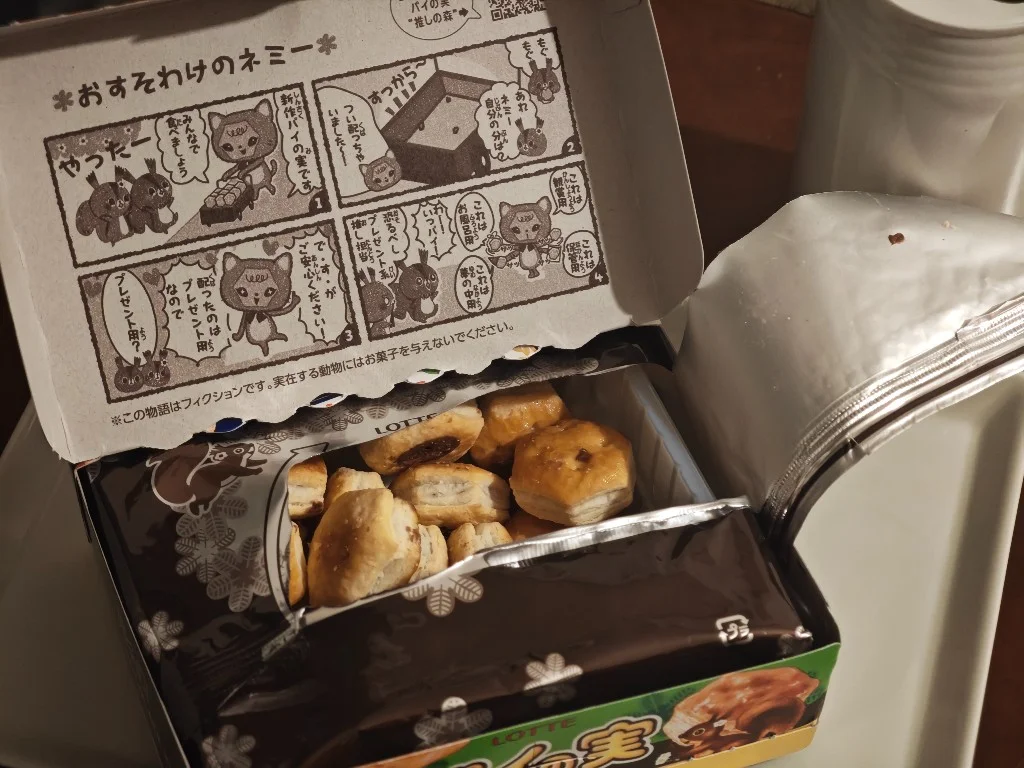 Open Pai no Mi carton showing lid comic and chocolate pies in the inner bag