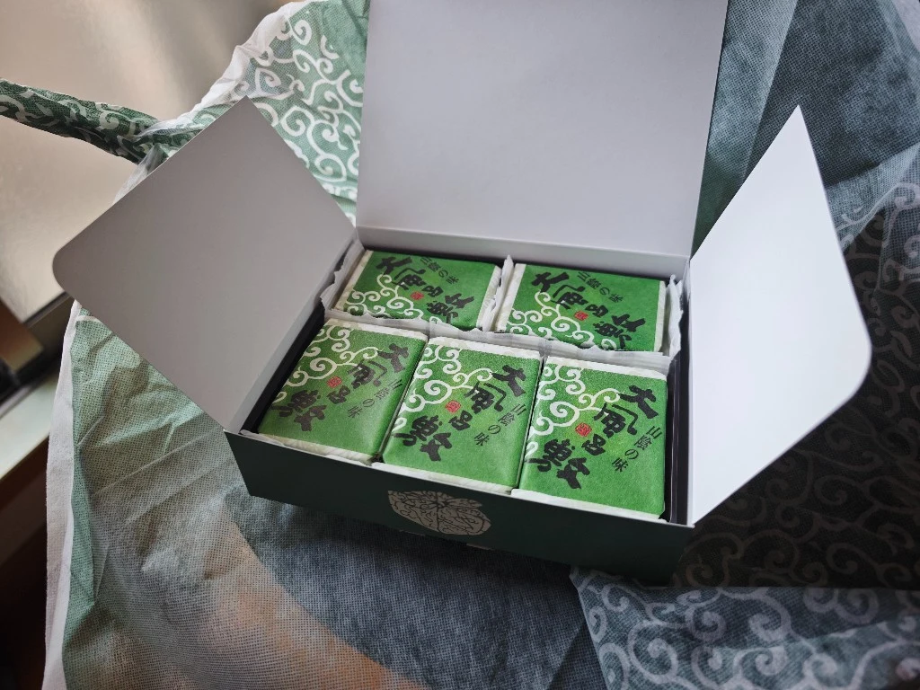 Opened Oburoshiki gift box containing five individually wrapped servings