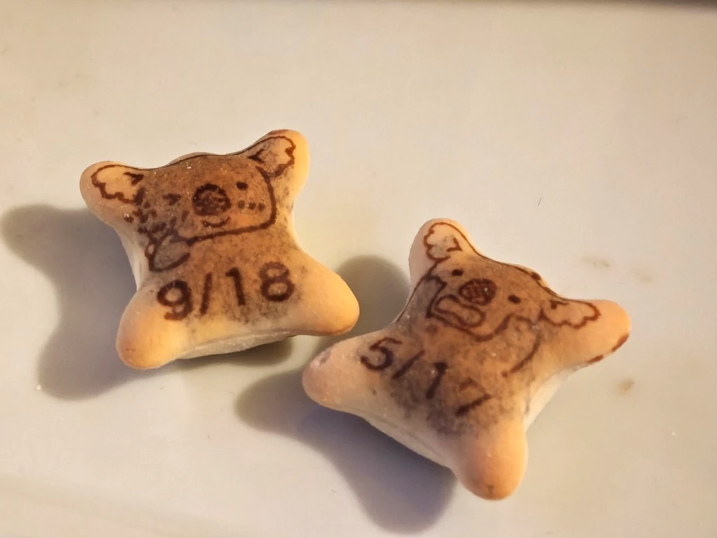Two Koala's March biscuits printed with different profile information