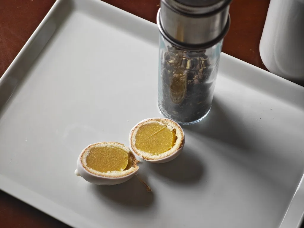 Kamome no Tamago Mini halves beside a black pepper mill