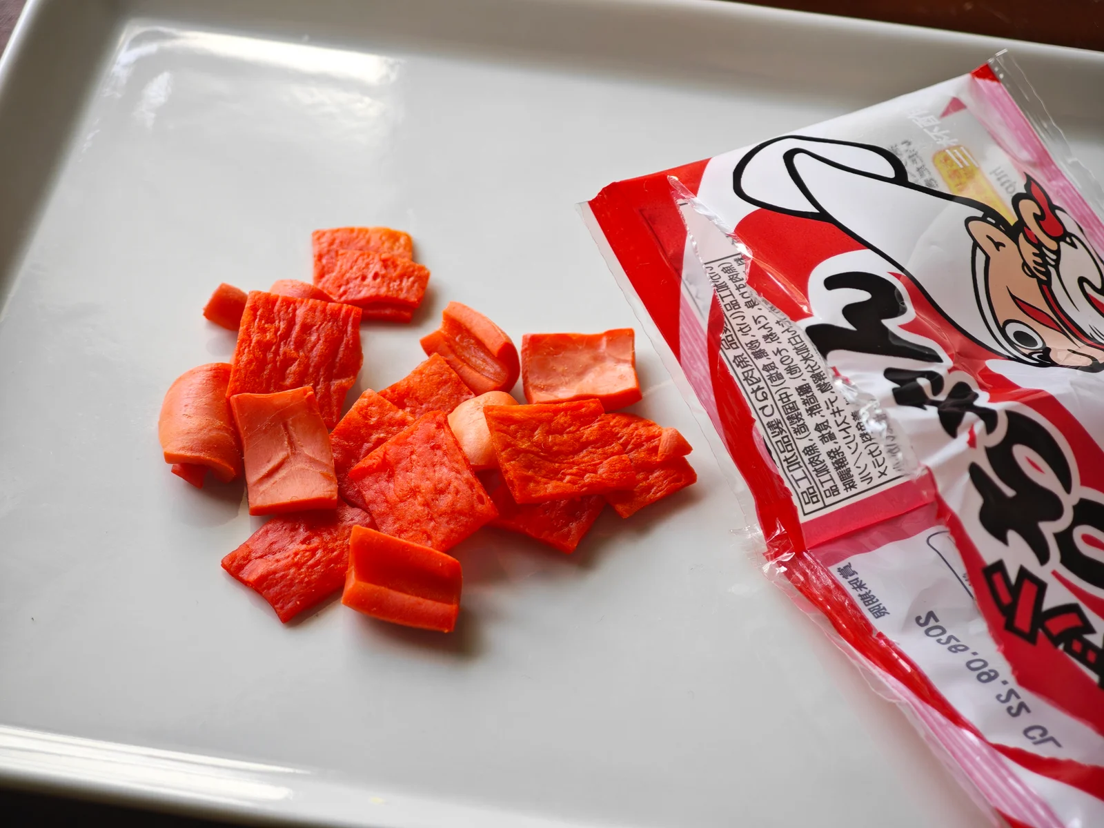 Opened Cut Yocchan poured onto a plate, showing squid pieces and fish-surimi sheets together