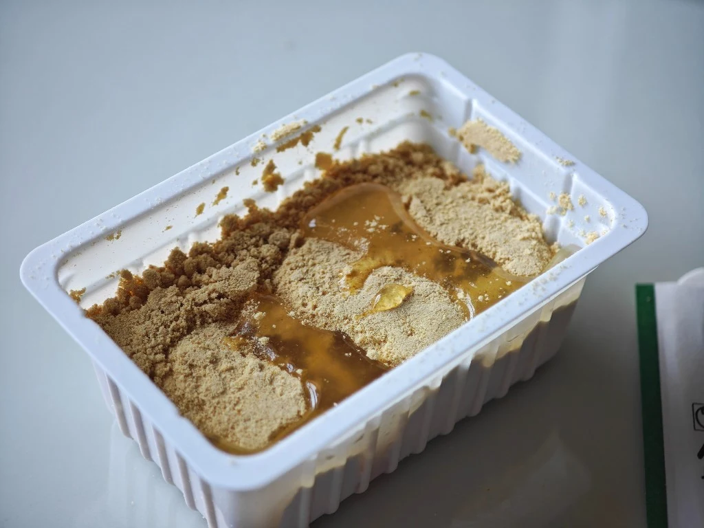 Pale pear syrup poured across Oburoshiki’s kinako mochi