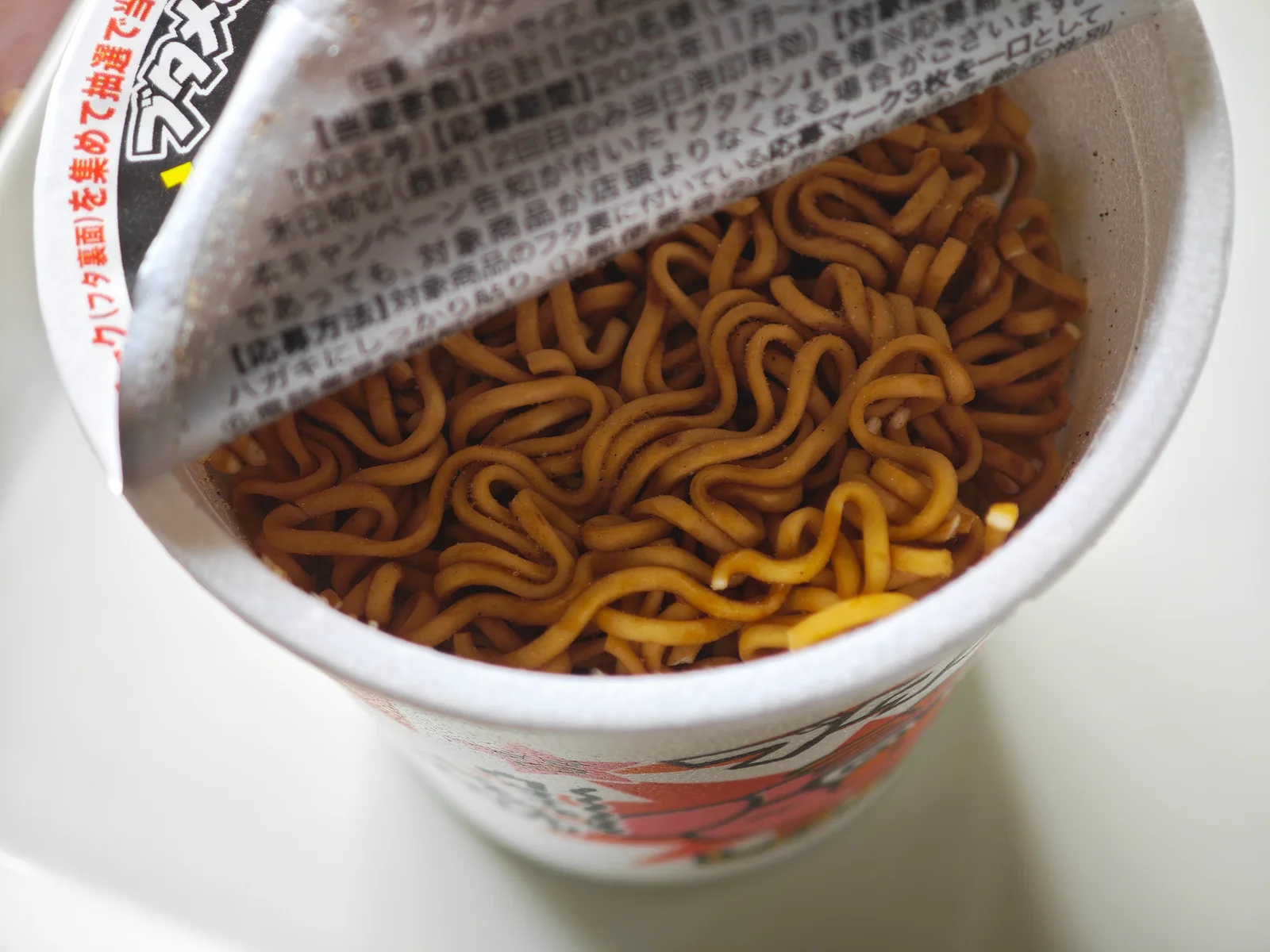 Dry noodles inside the opened shoyu Butamen cup