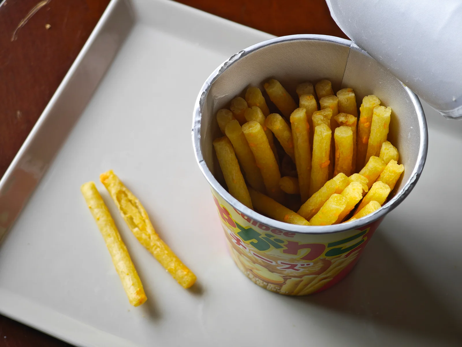 Opened Cheese Jagarico cup with two sticks set beside it