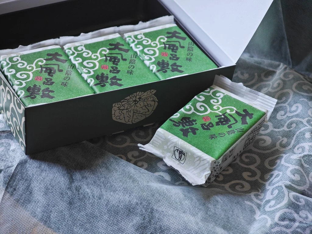 Oburoshiki gift box open beside one individually wrapped serving