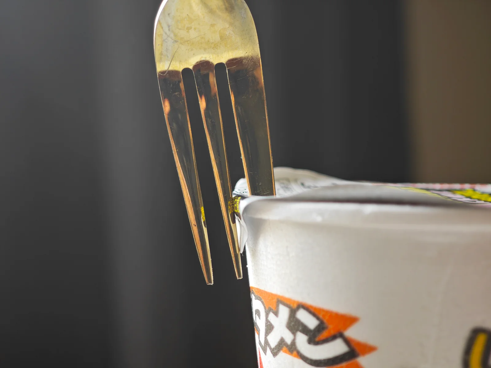 Plastic fork pinning the Butamen lid closed