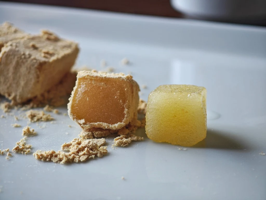 Cut Oburoshiki mochi beside a half with the kinako washed away