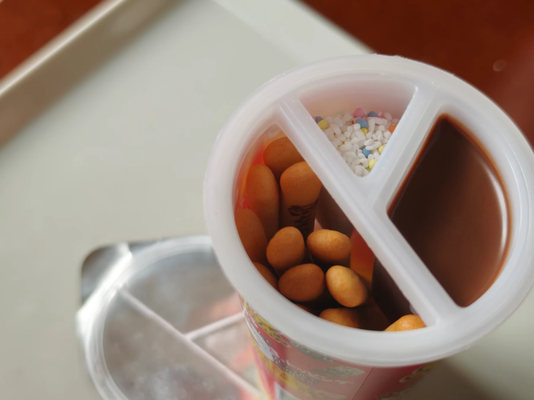 Opened chocolate Yan Yan Tsuke-bo showing crackers, topping, and cream