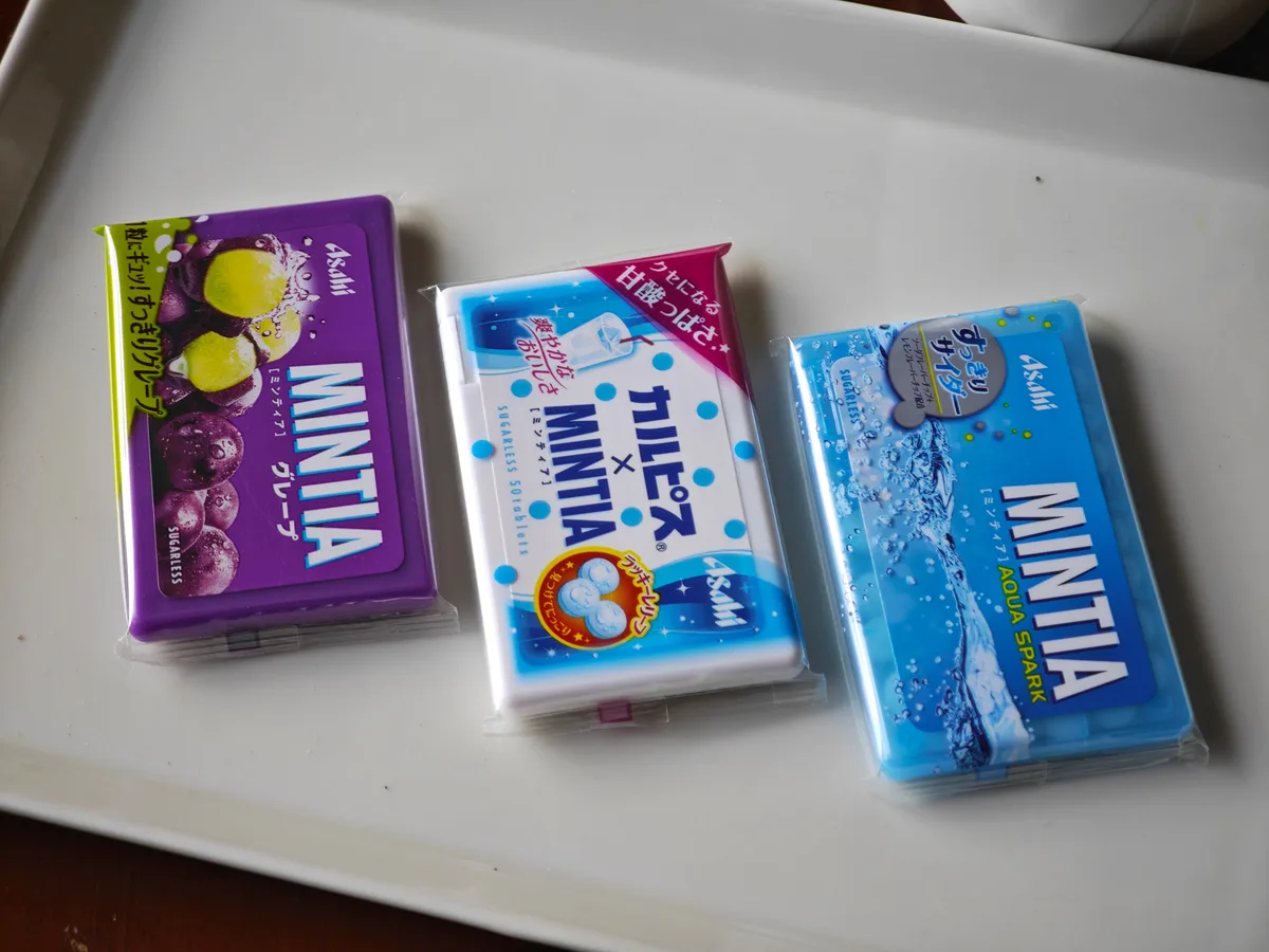 MINTIA Grape, Calpis, and Aqua Spark cases on a white plate