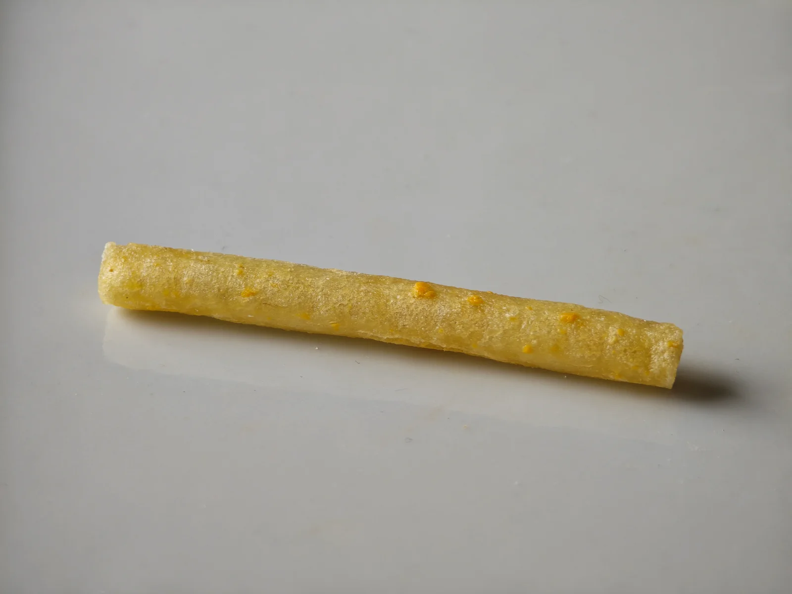 Close-up of a Cheese Jagarico stick with orange cheese flecks