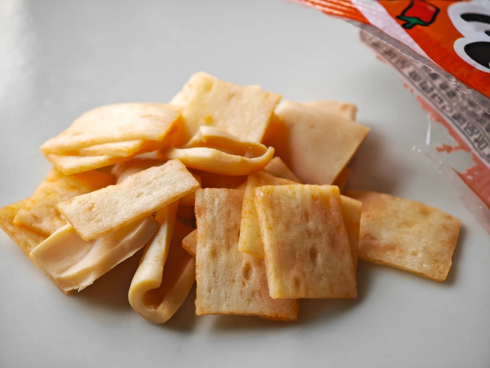 Close-up showing chili-tomato seasoning soaked into Cut Yocchan pieces
