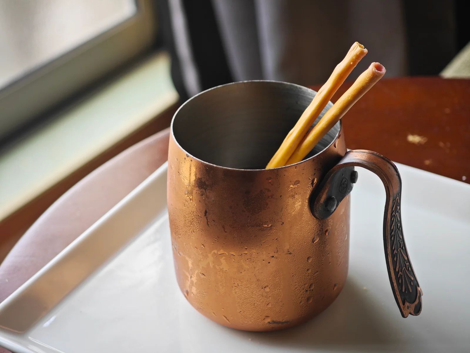 Toppo sticks soaking in a glass of iced coffee