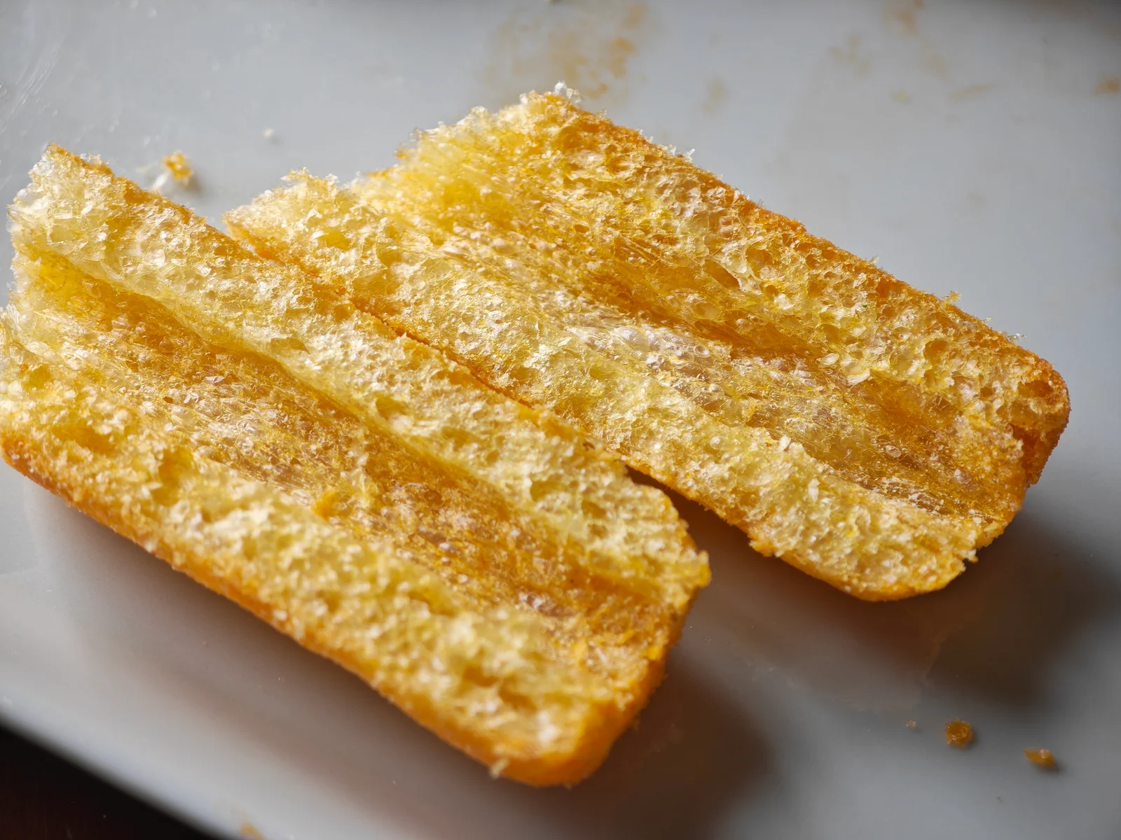 Umaibo split lengthwise, showing the central tunnel and porous corn-puff wall