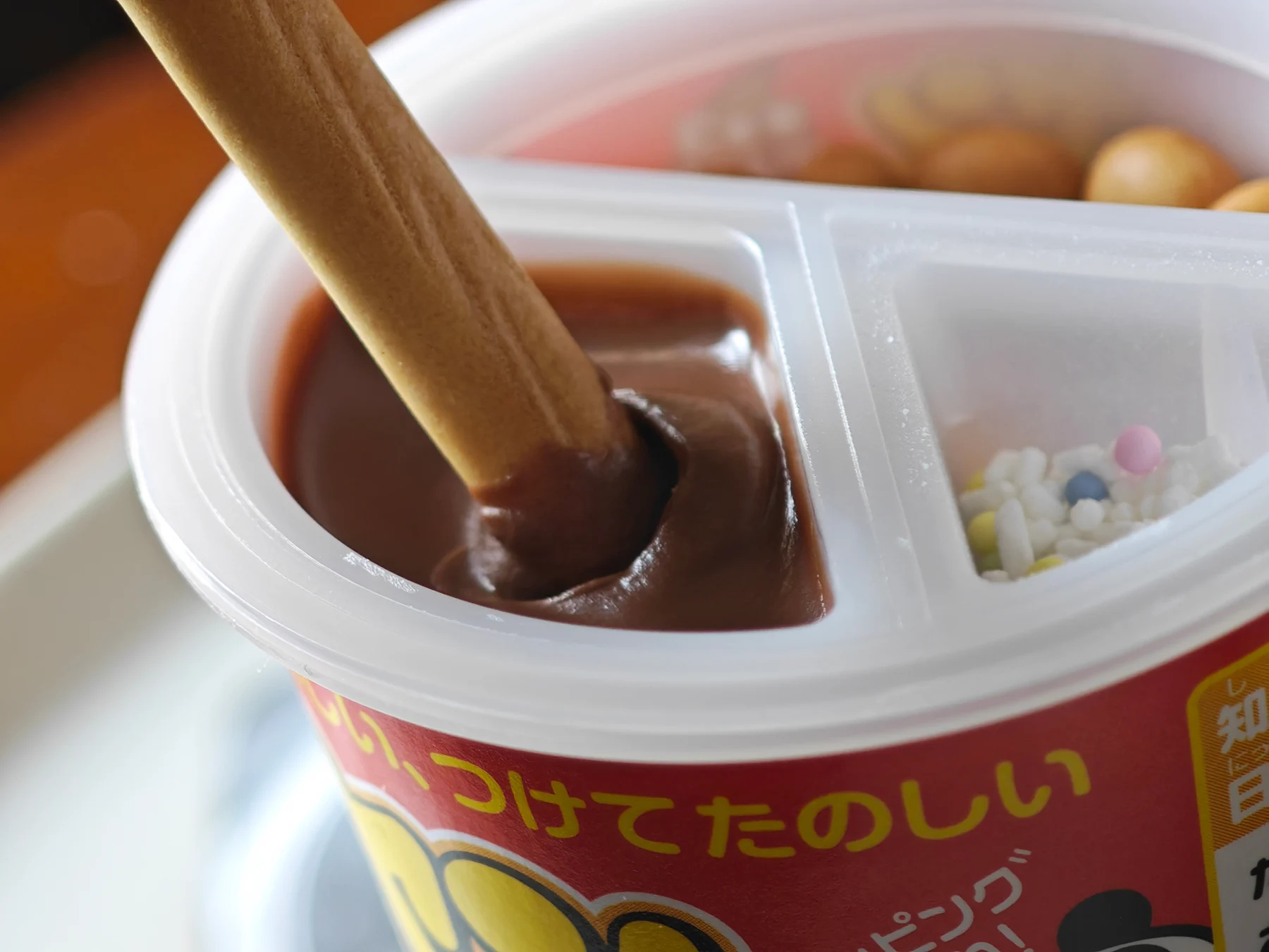 A cracker entering the chocolate cream well