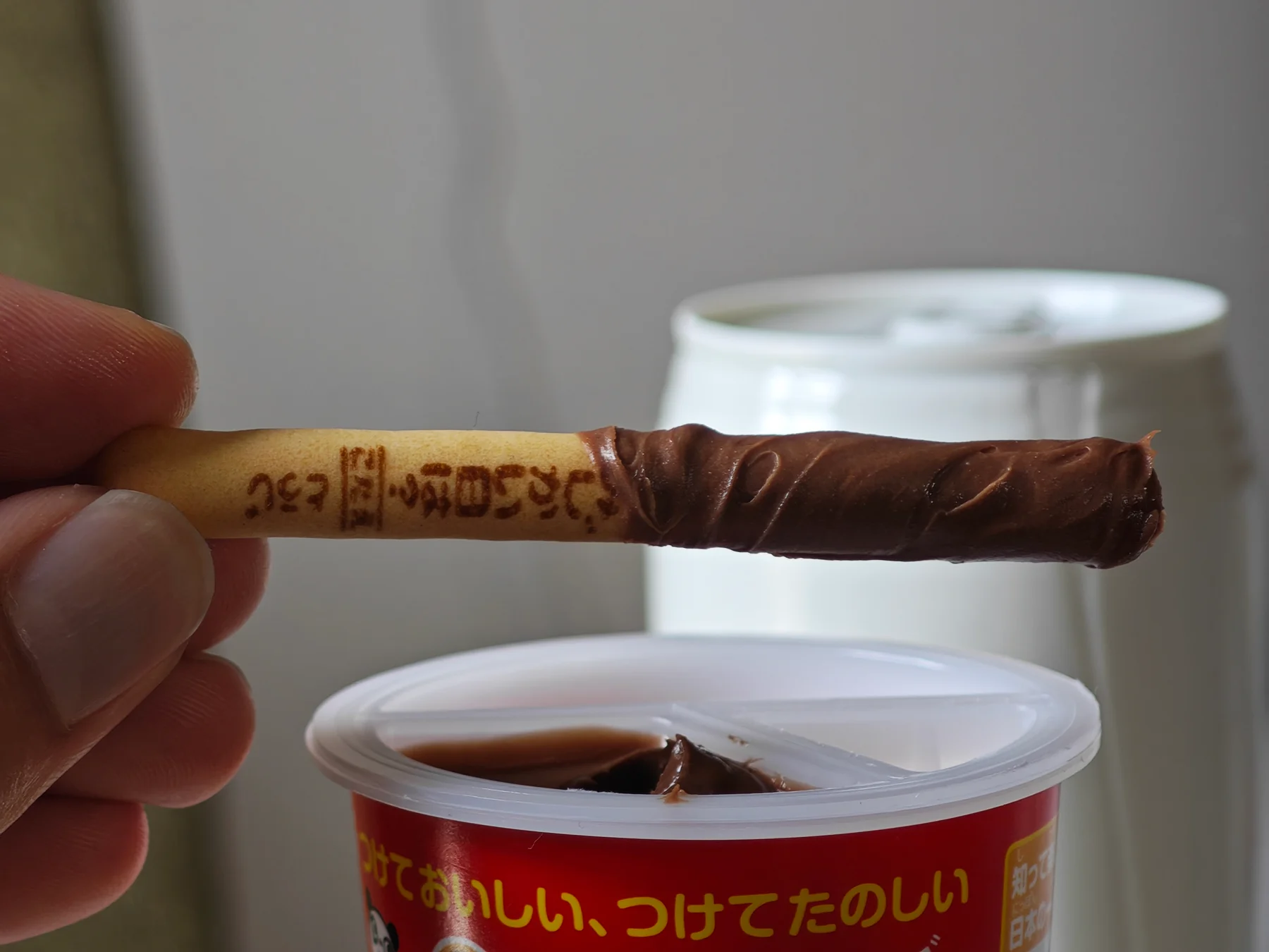 A Yan Yan cracker coated in chocolate cream