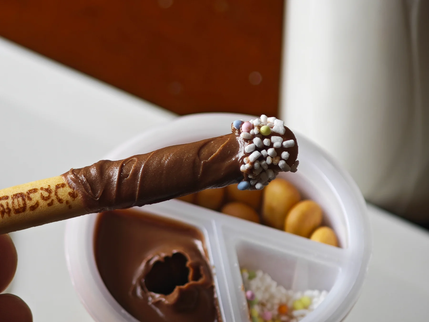 Chocolate Yan Yan stick with topping concentrated at its tip