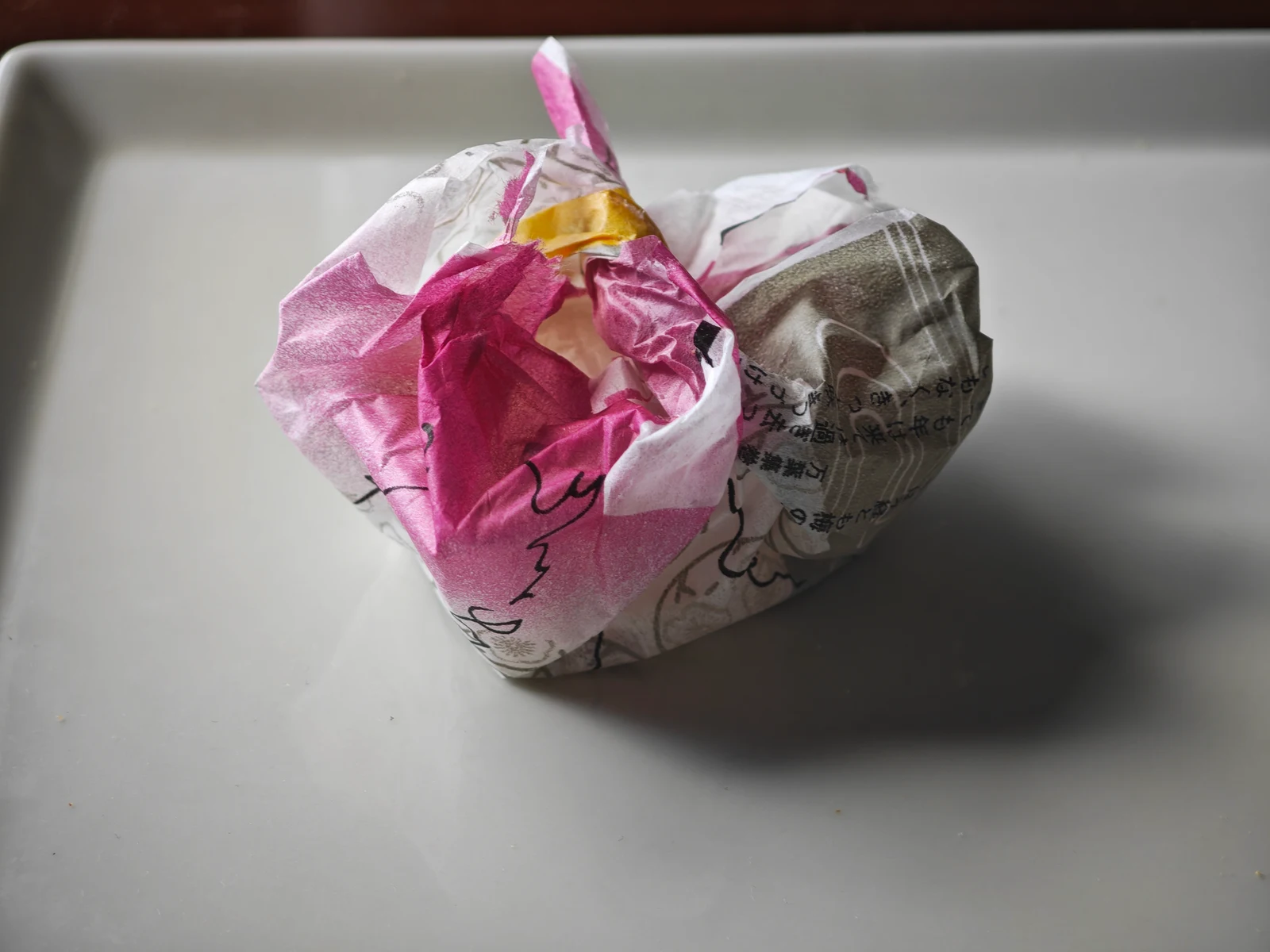 Empty Tsukushi Mochi serving compactly bundled in its original wrapper