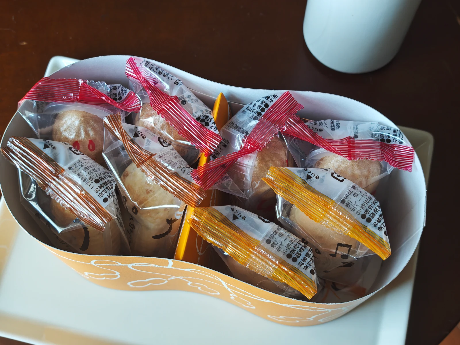 Opened Chiba Meguri box with individually wrapped Peanut Monaka, Manju, and Pie seen from above