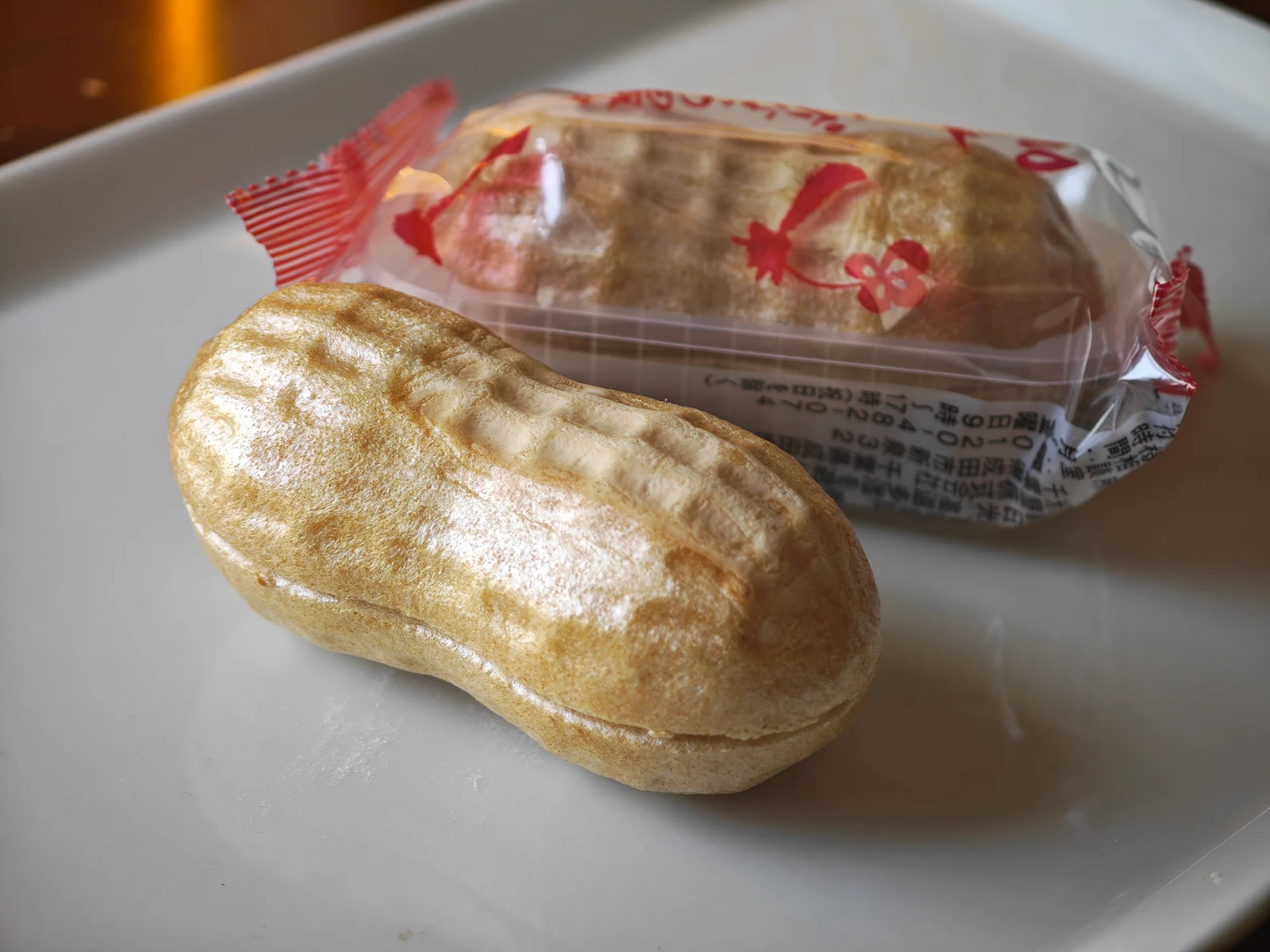 Unwrapped Peanut Monaka beside its red-patterned individual package
