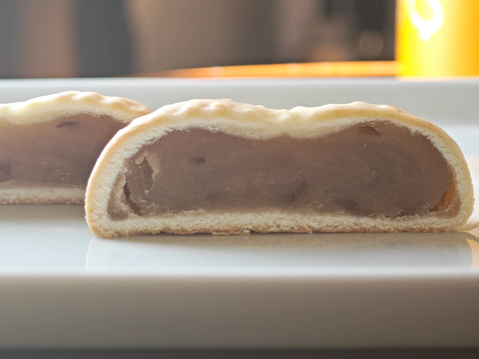 Cross-section of Peanut Manju showing a soft baked crust around pale peanut bean paste